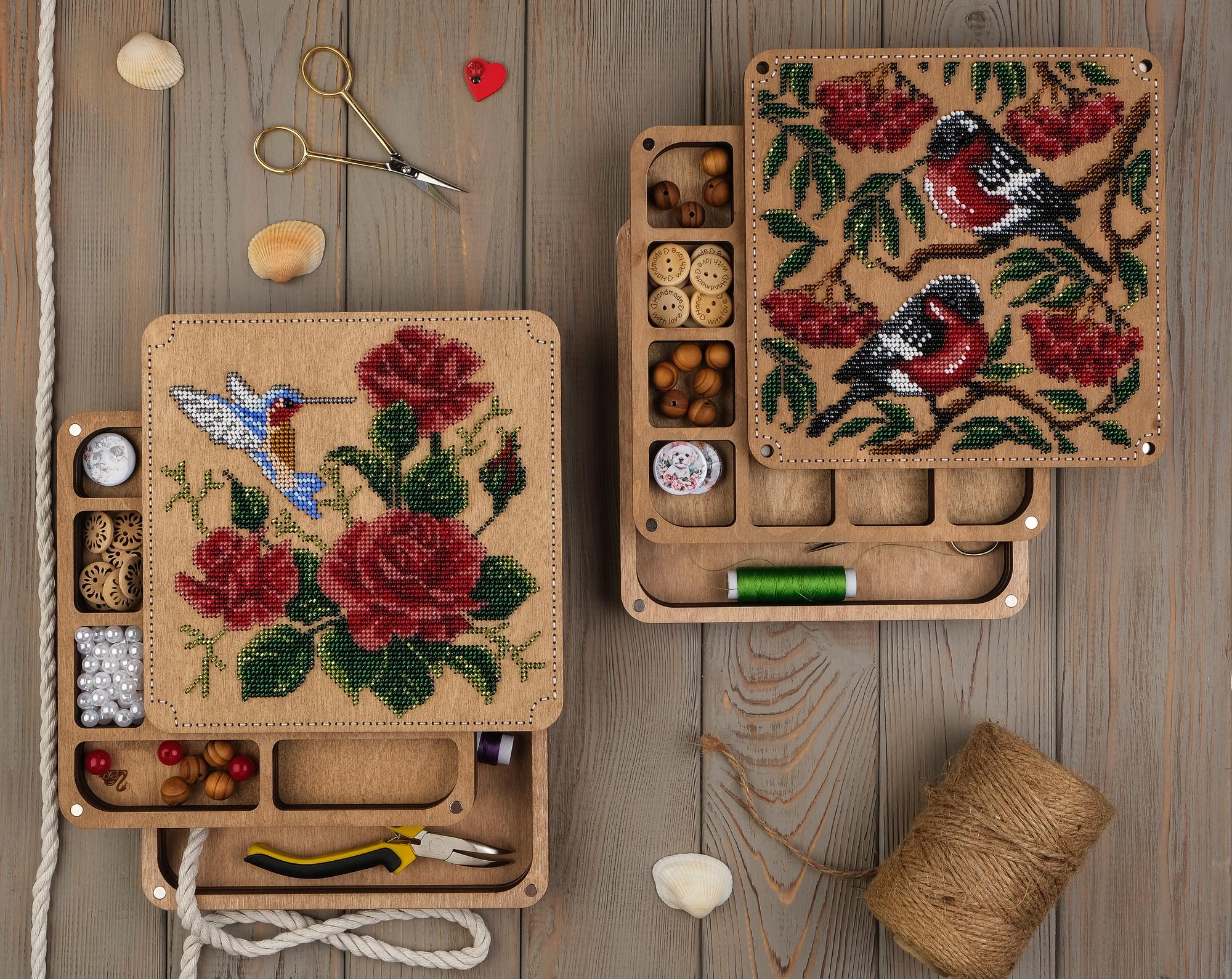 Stack of embroidered samples on a wooden tray