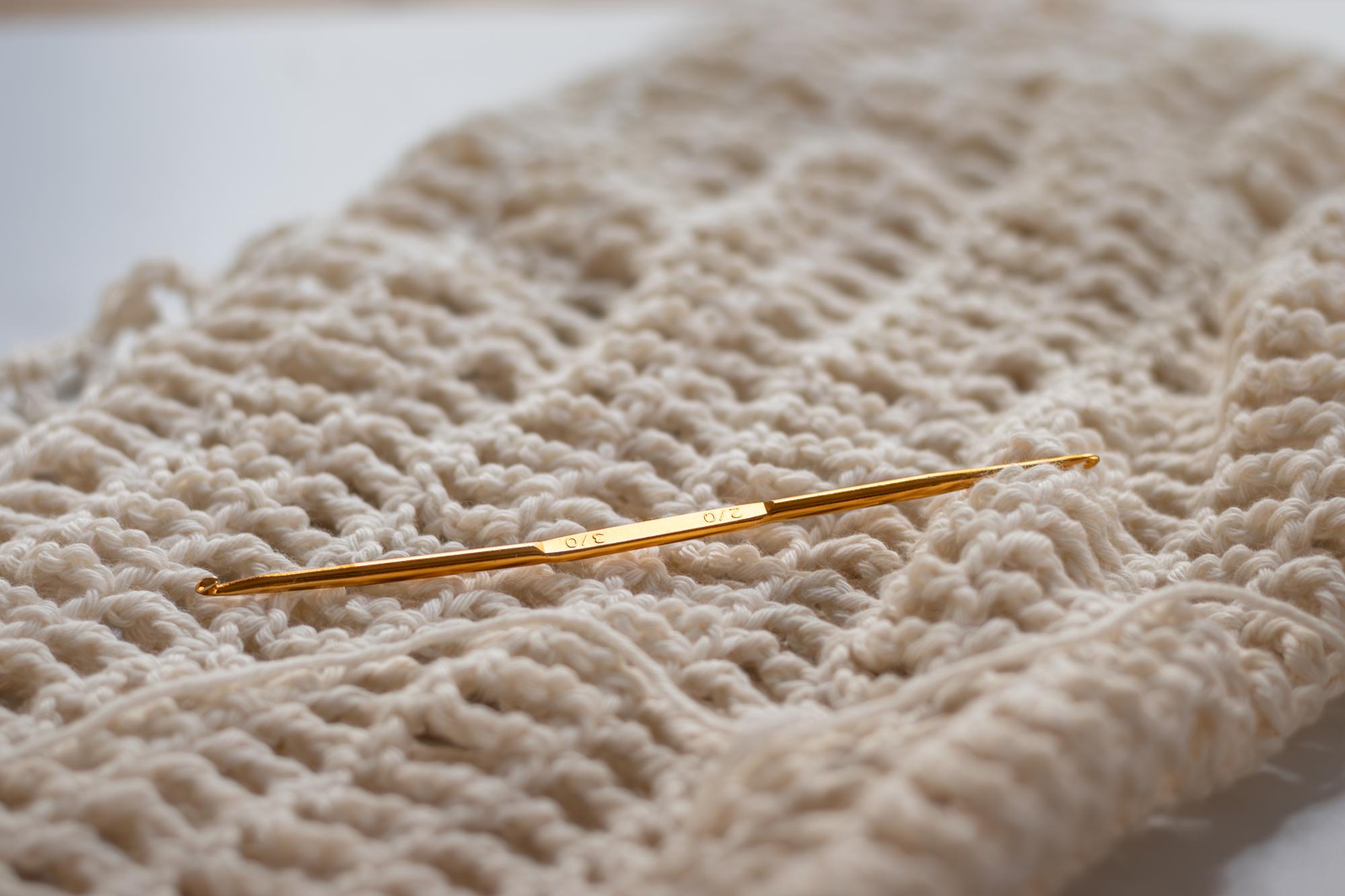 Close-up of hand embroidery with gold thread